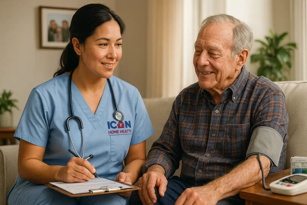Hispanic female nurse in light blue scrubs with the Icon Home Health logo providing in-home advanced disease management, taking a senior male patient’s blood pressure in a cozy living room