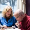 woman helping a man eat