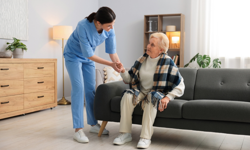 Licensed nurse providing medical care during a home visit with a patient