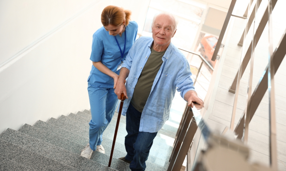 Senior receiving balance therapy and fall prevention exercises at home