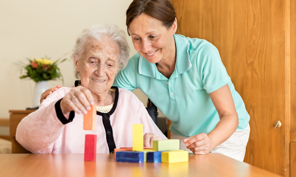 Occupational therapist helping senior patient with daily activities at home