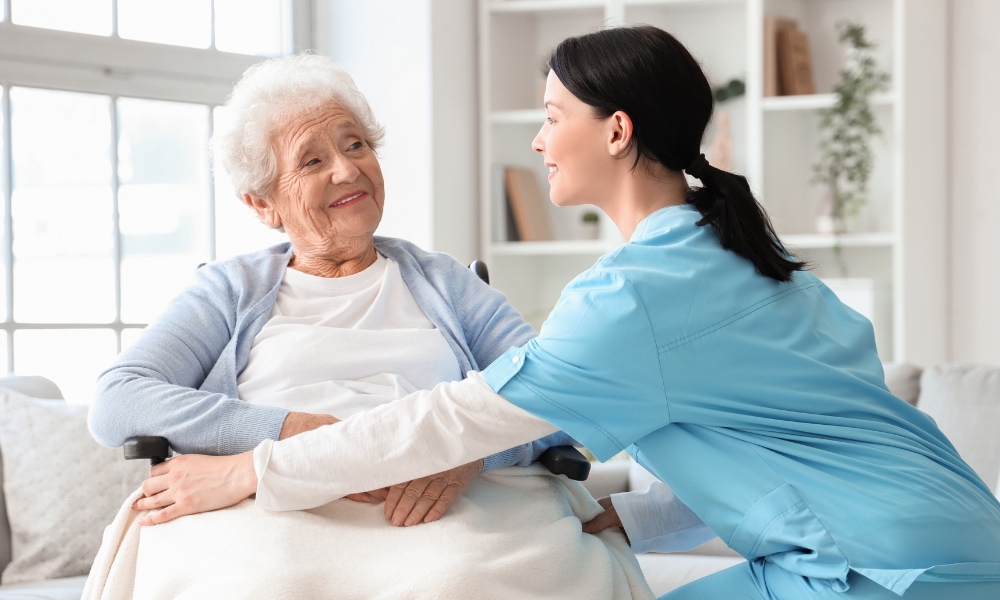 Caregiver providing personal care and daily assistance to senior at home