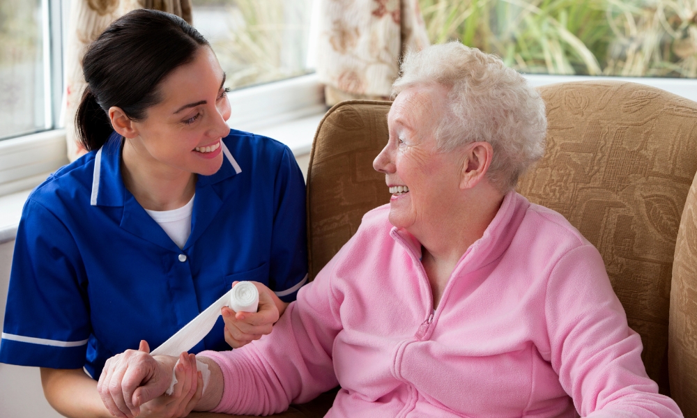 Professional nurse providing wound care treatment for a patient at home